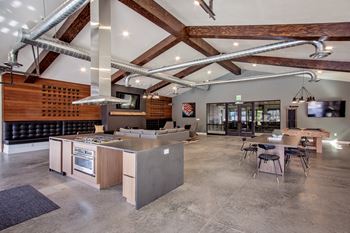 A modern kitchen with a wooden wall and a large island.